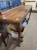 Edwardian mahogany dining table of narrow rectangular form raised on tapering legs with pad feet,