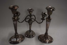 Pair of silver plated on copper candlesticks together with a further candleabra (3)