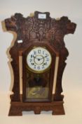 Late 19th Century American gingerbread type mantel clock with carved case