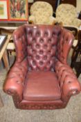 Red buttoned leather Chesterfield style wing chair