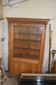 Pine glazed side cabinet with single door and shelved interior, 109cm wide