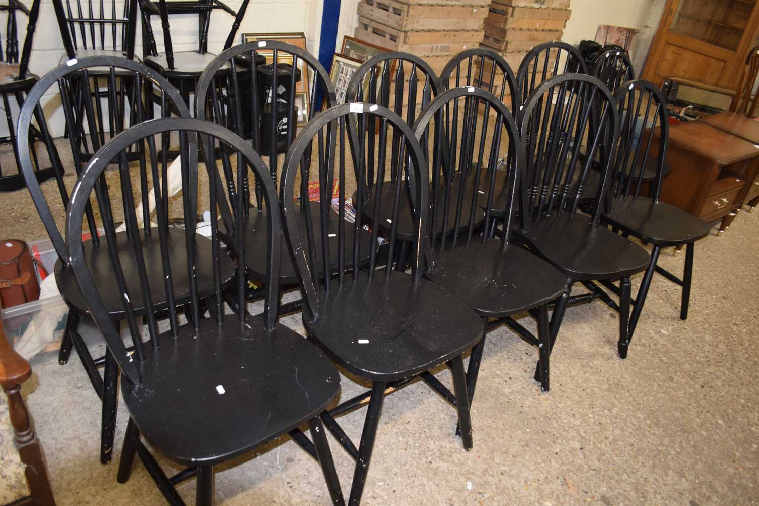 Eleven black painted stick back kitchen chairs