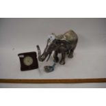 Silvered resin model of an elephant together with a small metal model bird and a vintage travel