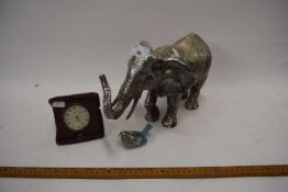 Silvered resin model of an elephant together with a small metal model bird and a vintage travel