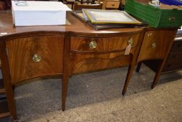 Edwardian mahogany serpentine front sideboard with three drawers and one door raised on tapering