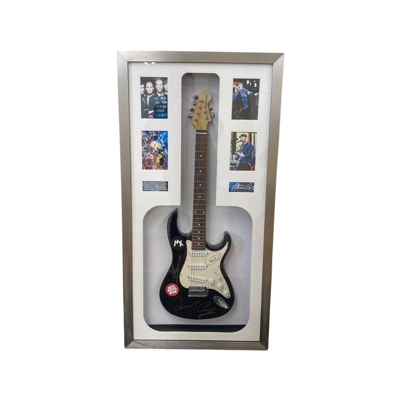 A framed electric guitar signed in gold pen by Coldplay, with promotional photographs for their 2011