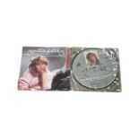 A pair of 7'' singles from Agnetha Faltskog of Abba, to include: - The Heat is On picture disc -