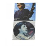 A pair of Beatles interest 12" vinyl LPs, to include: - Paul McCartney, Spies Like Us Picture Disc -