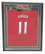 A framed and glazed Manchester United shirt signed by Ryan Giggs, #11. COA to rear, from