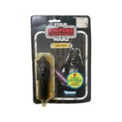 A 1982 Kenner Star Wars: The Empire Strikes Back Darth Vader figurine. In original carded packaging