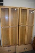 Pair of light wood corner display cabinets