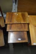 Nest of three reproduction mahogany veneered occasional tables