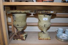 Small pair of cast iron urns, 26cm high