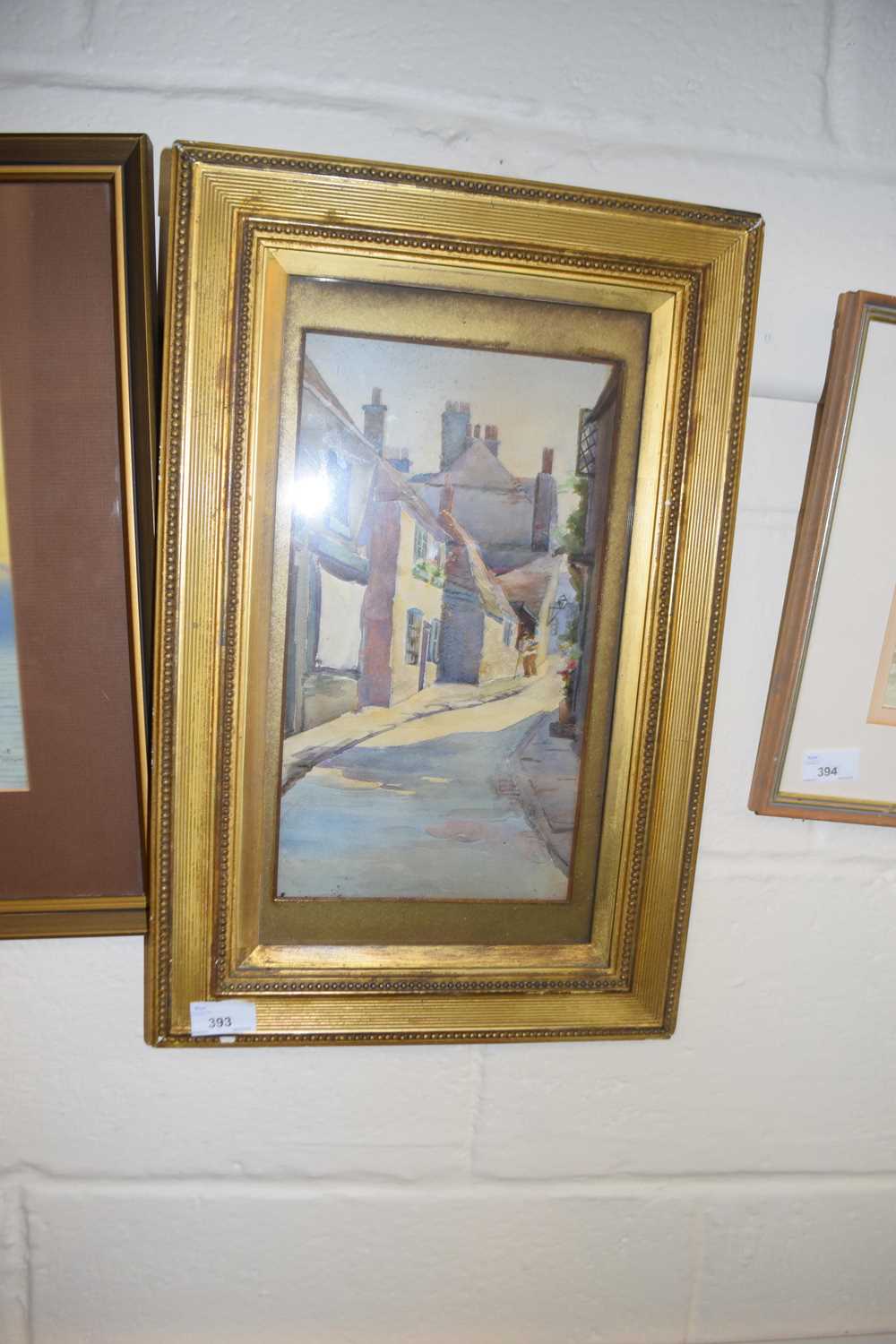 A early 20th Century school study of a village street scene, watercolour, unsigned, framed and