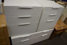 Pair of modern white three drawer bedside cabinets together with a matching four drawer chest