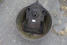 Cast iron wall mounted fountain head together with a iron trough