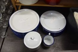 Collection of white enamel plates together with a similar storage jar and mug