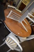 Modern circular kitchen table together with five various stick back chairs