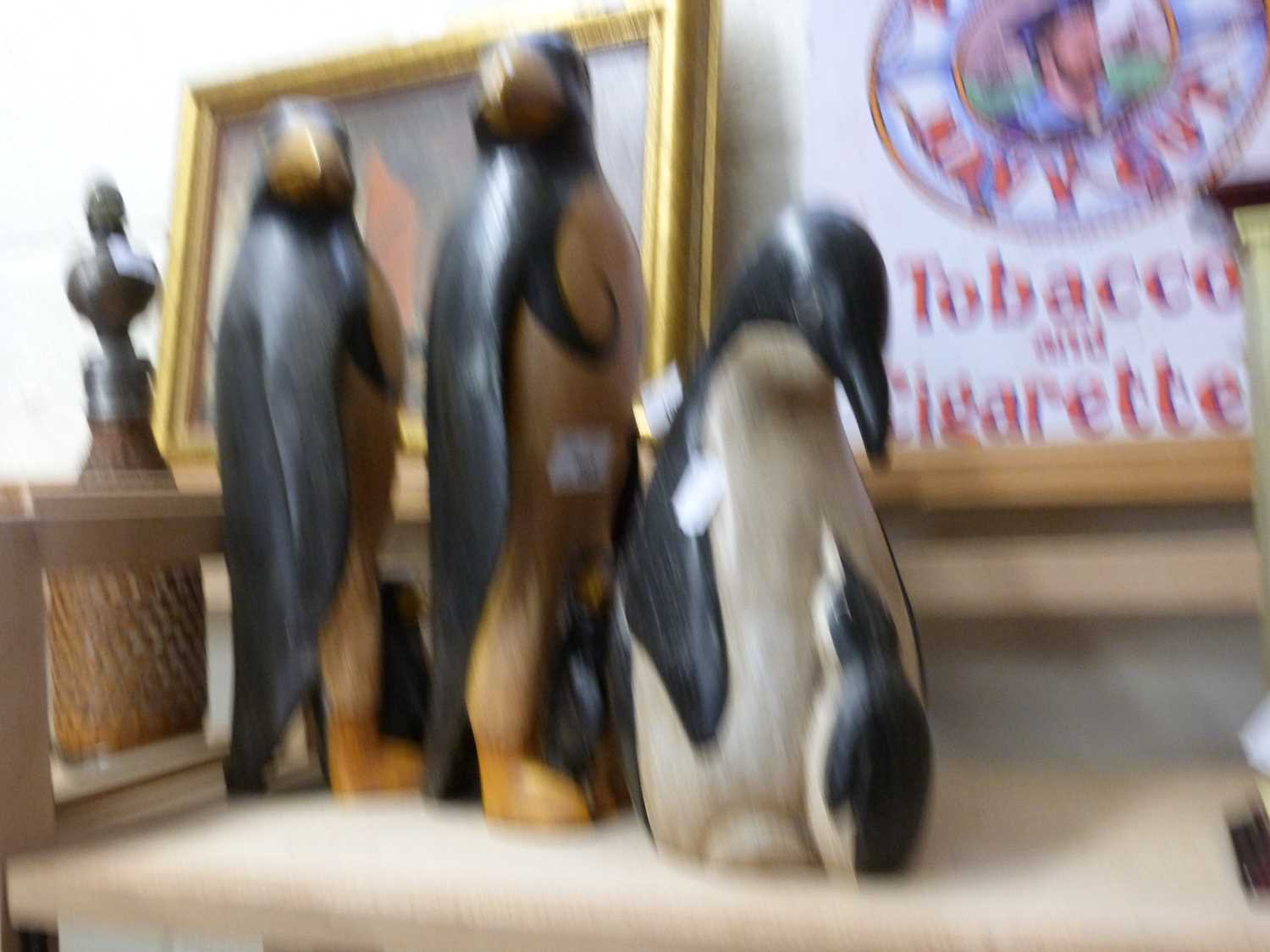 Three modern wooden models of penguins