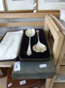 A cased pair of silver plated serving spoons and a cased set of fish cutlery