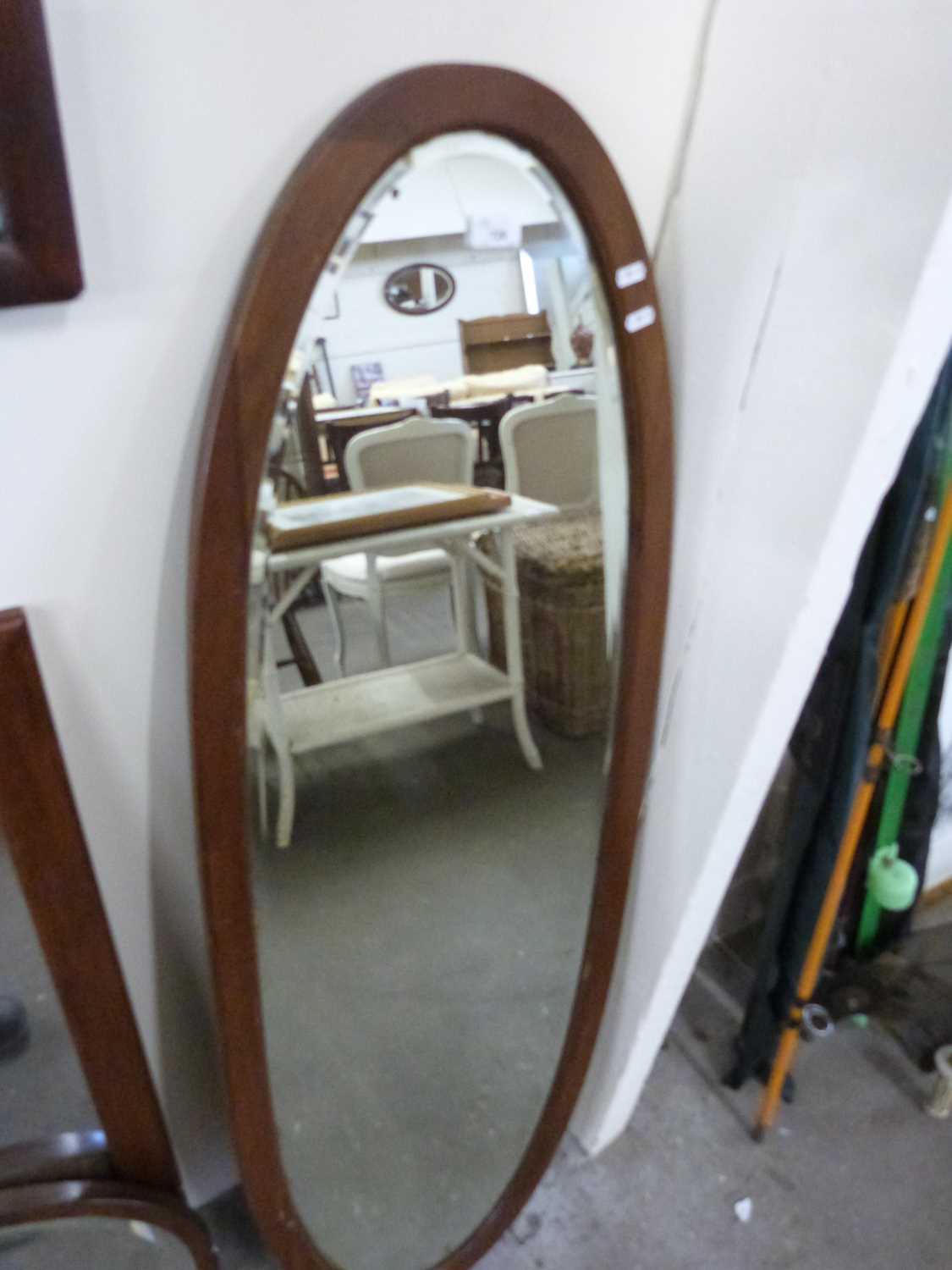 Large oval bevelled wall mirror in hardwood frame