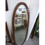 Large oval bevelled wall mirror in hardwood frame