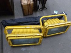 Pair of large yellow painted flood lights