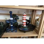 Mixed Lot: Cast iron boot scraper, lighthouse shaped door stop, two tier egg stand and a pocket