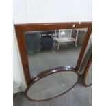Rectangular wall mirror together with a further oval bevelled wall mirror