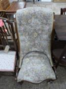 Victorian floral upholstered scroll back nursing chair on turned legs with casters