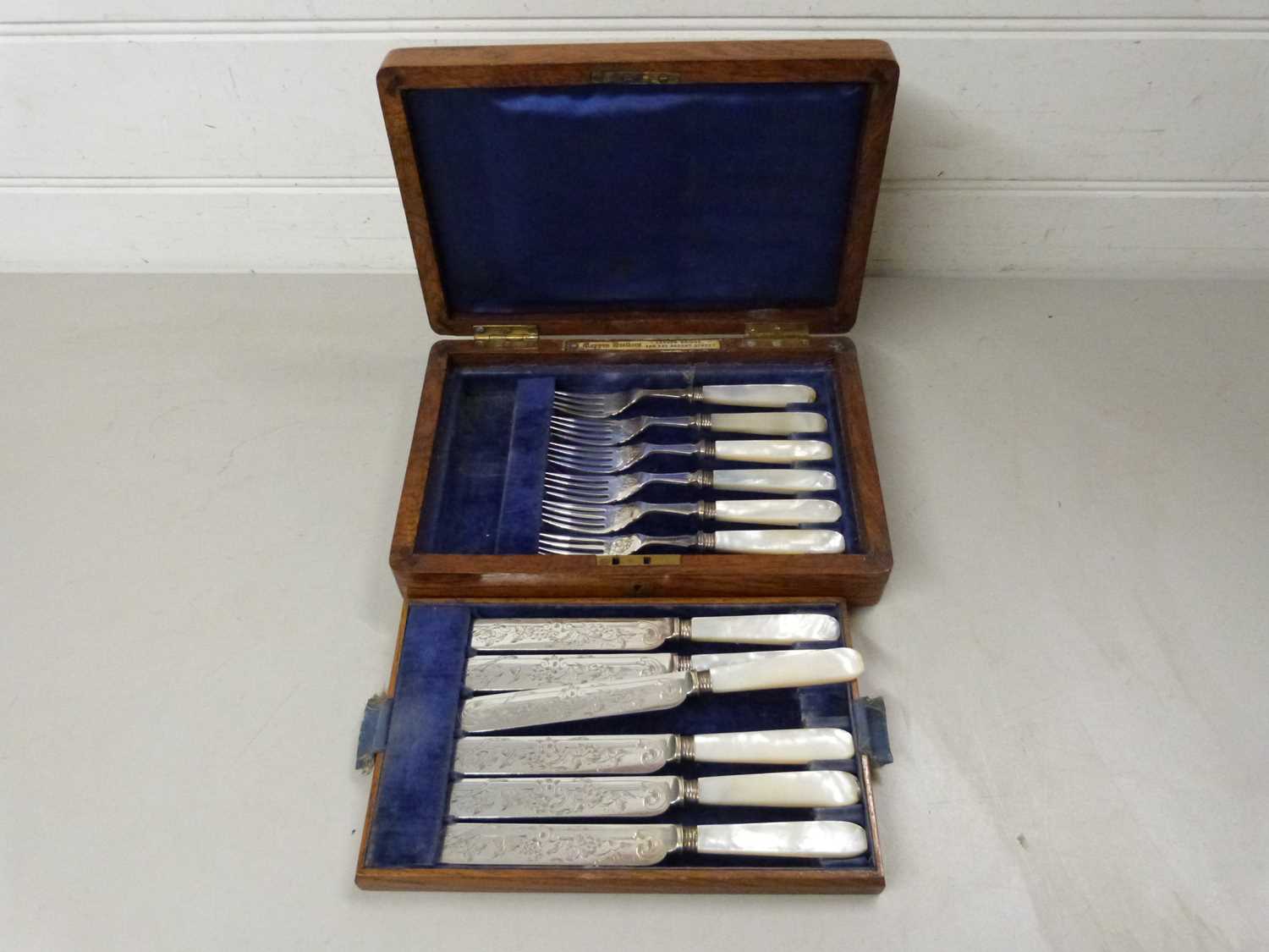 Case of mother of pearl handled dessert cutlery, the case with retailers mark for Mappin Bros London