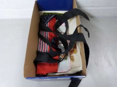 Box containing various tapestry and needlework fragments, a Thai baby carrier and other items