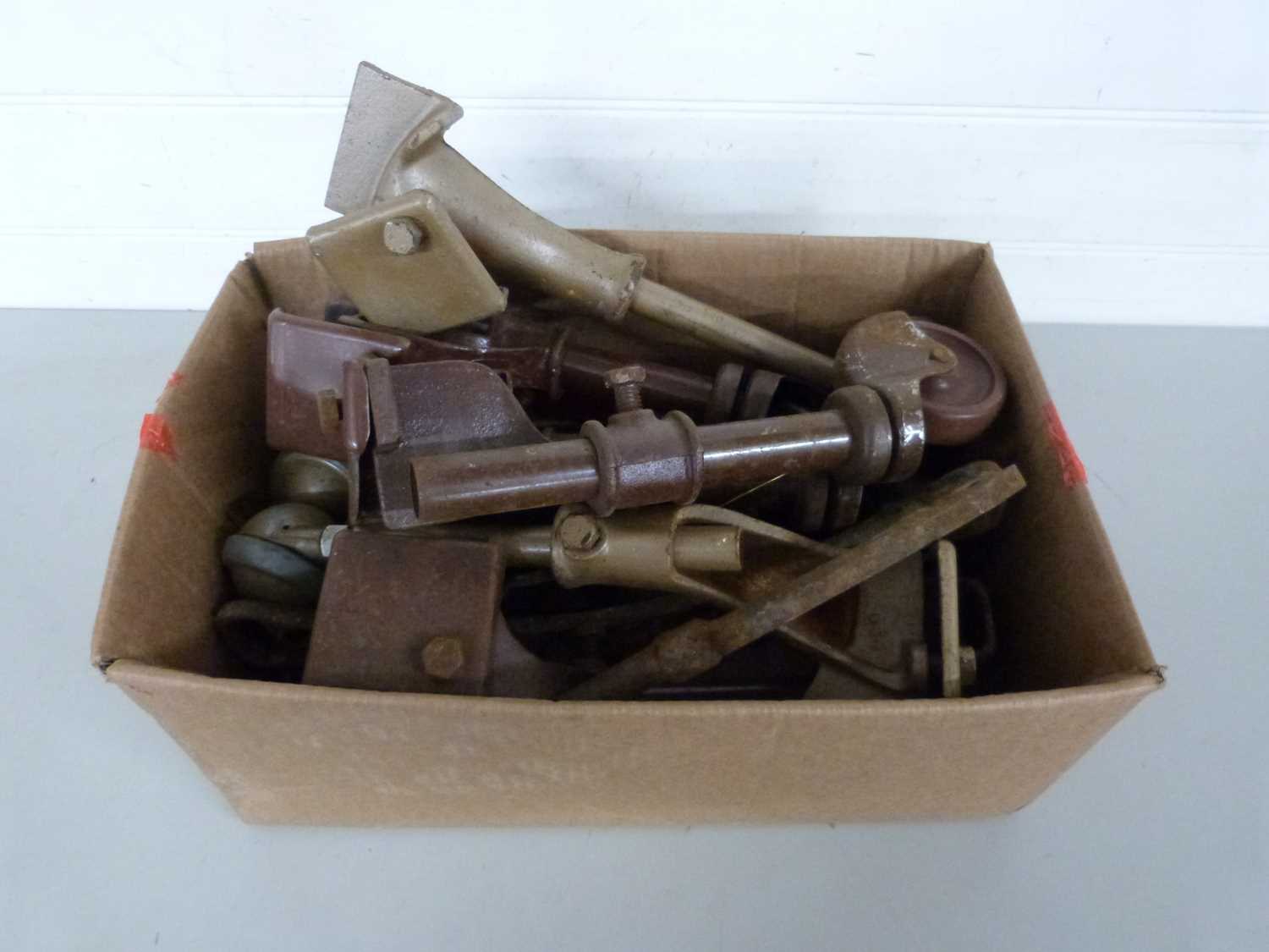 Box of vintage iron wheels probably from beds