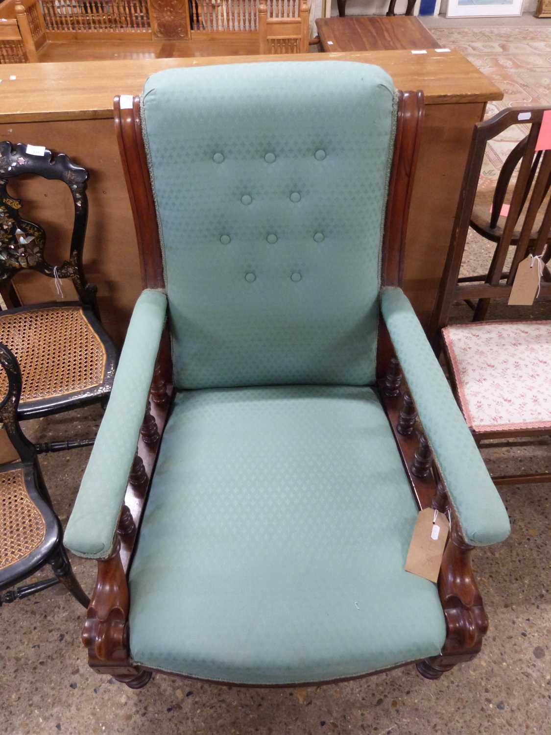 Victorian mahogany framed button back armchair, the arms with spindle turned decoration