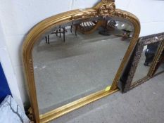 Modern arched over mantel mirror in gilt effect frame