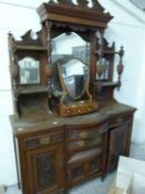 Late Victorian American walnut mirror back sideboard of architectural form decorated with carved