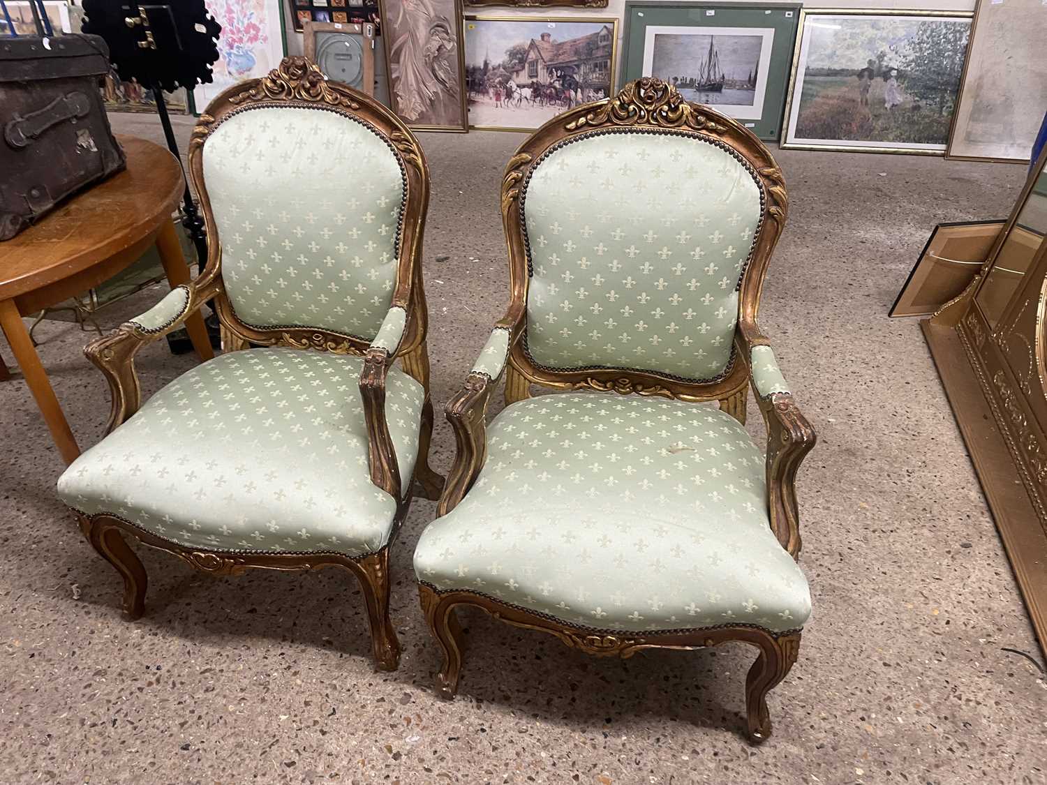 Gilt wood framed armchairs upholstered in pale green fabric
