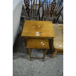 Nest of three walnut veneered occasional tables