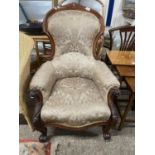 Victorian mahogany framed armchair with scroll arms and feet raised on casters