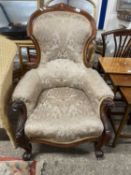 Victorian mahogany framed armchair with scroll arms and feet raised on casters
