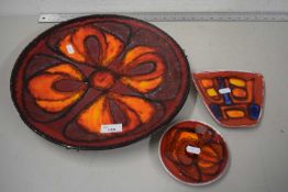 Poole Pottery charger together with two similar small dishes (3)