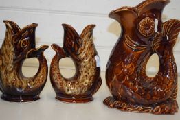 Two Dartmouth Potter gurgle jugs together with a similar Arthur Wood example
