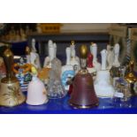 A collection of various novelty porcelain hand bells and other items