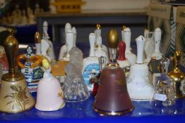 A collection of various novelty porcelain hand bells and other items