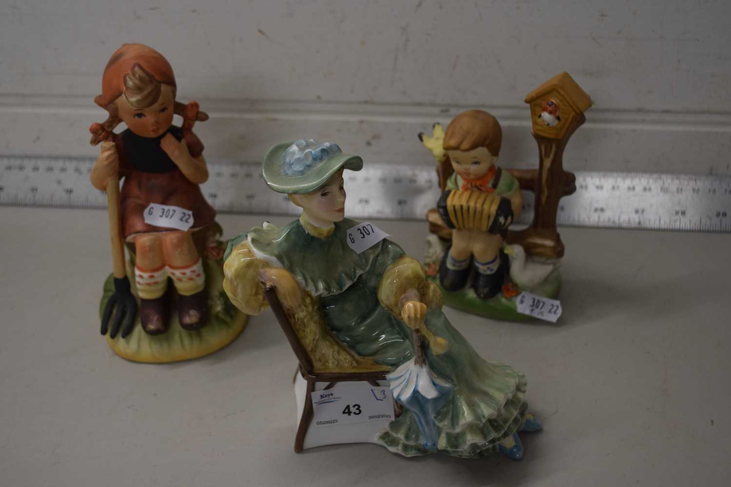 Mixed lot comprising a Royal Doulton figurine, Ascot plus two further Gobal style figures (3)