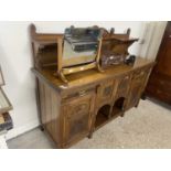 Late Victorian oak sideboard with shelved back over a base with two drawers and four panelled