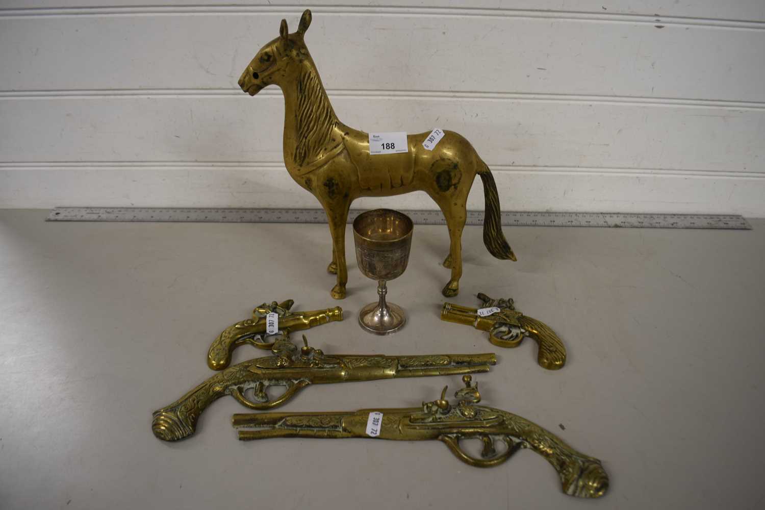 Mixed Lot: Cast brass gun shaped wall ornaments, a brass horse and a silver plated goblet