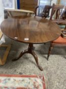 Georgian mahogany supper table with circular single plank top over a turned column and tripod