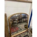 Modern arch top over mantel mirror set in a gilt frame