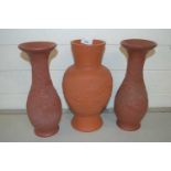 Three modern Oriental terracotta vases decorated with dragons